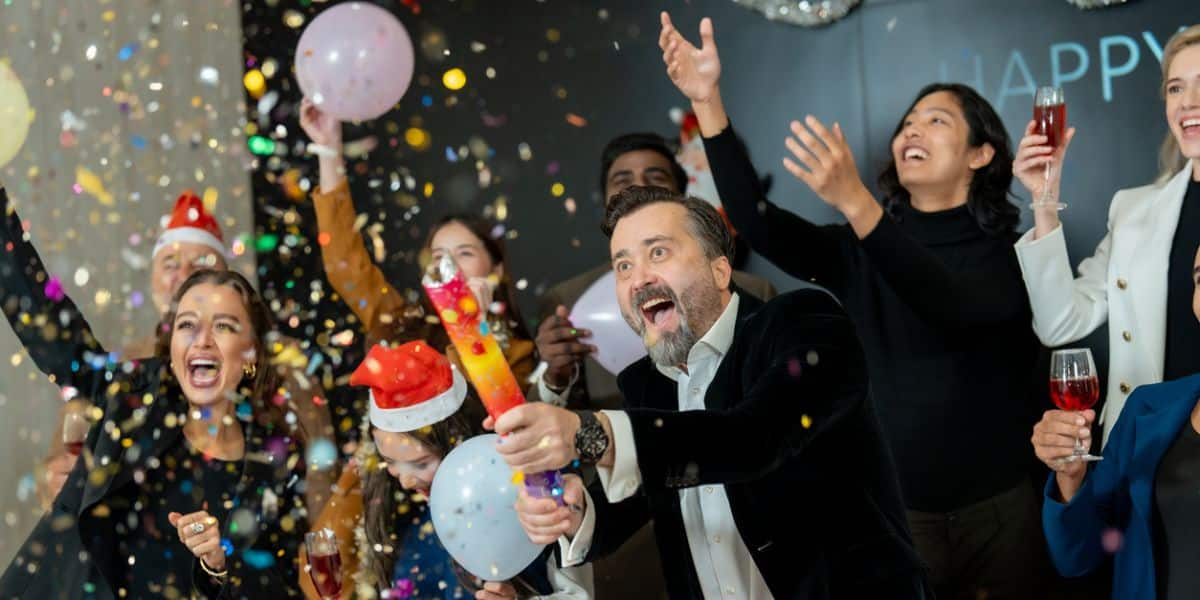 A small business team celebrates the success of their business thanks to ActionCOACH strategies.