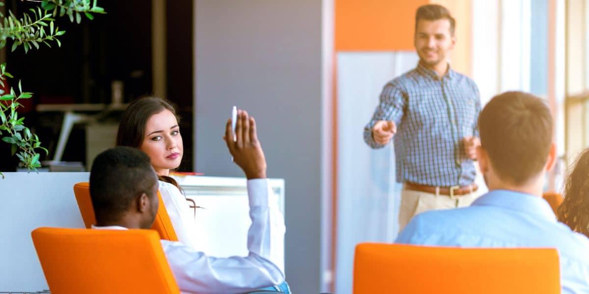 Employee engagement survey providers speaks to a team for feedback.