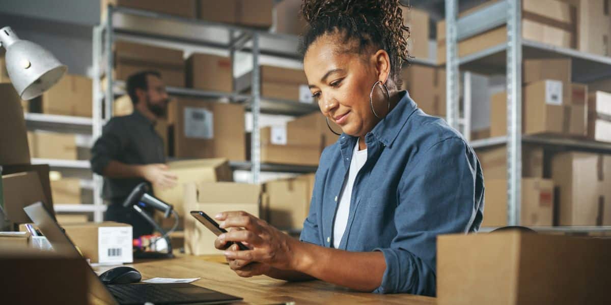 Two small business owners work in their shop to calculate mom and pop business funding.